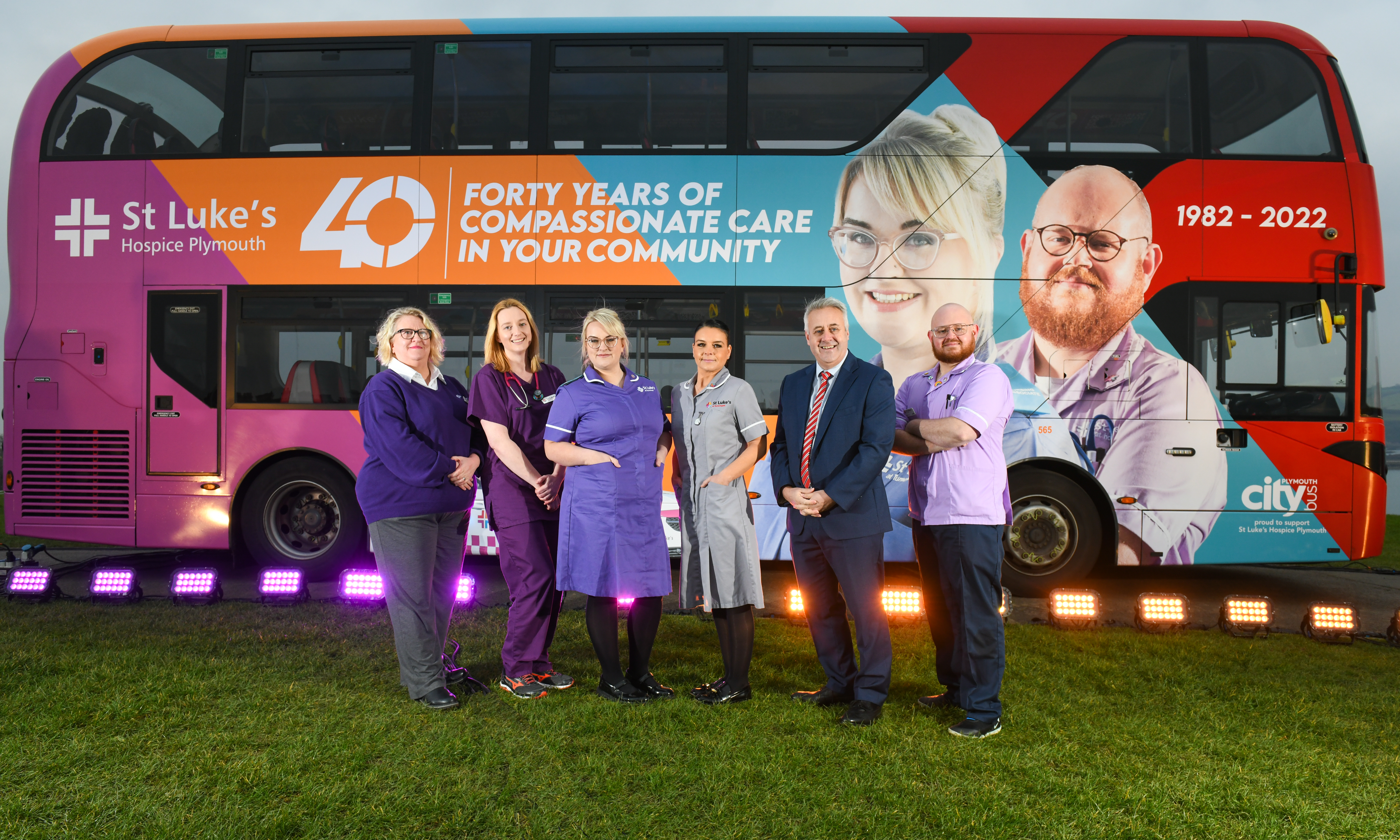 St Luke's staff and Plymouth Citybus MD Richard Stevens standing with the branded bus