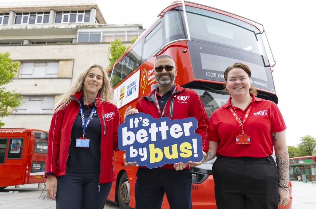 Picture of 3 members of Plymouth Citybus staff in front of a red double decker bus 